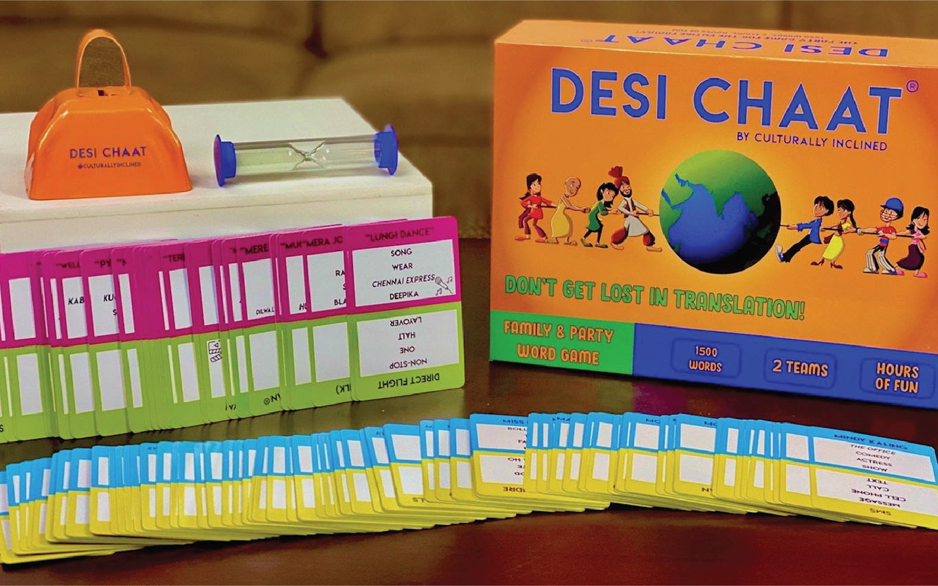 Desi Chaat box standing behind rows of word cards, with the cowbell on the table