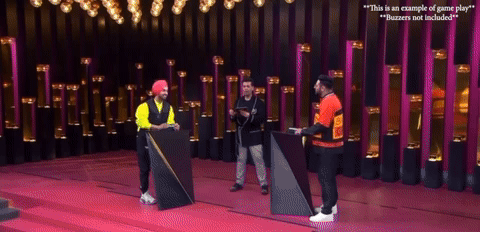 Two players on stage competing to guess the Bollywood song in English Singlish