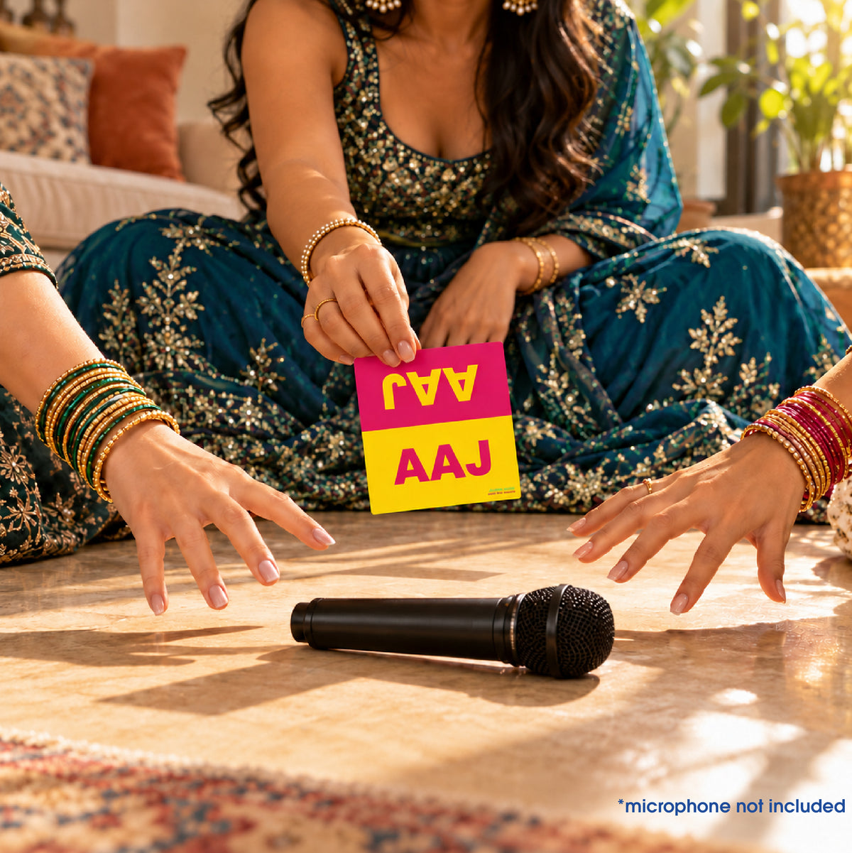 Gaana Grab players reaching for a pretend microphone while the host reveals the AAJ card; microphone not included