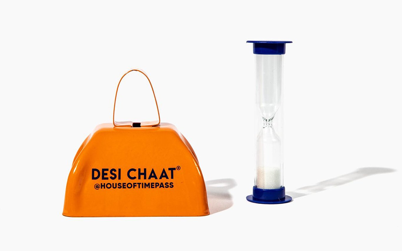 The Desi Chaat cowbell and sand timer that come inside the box
